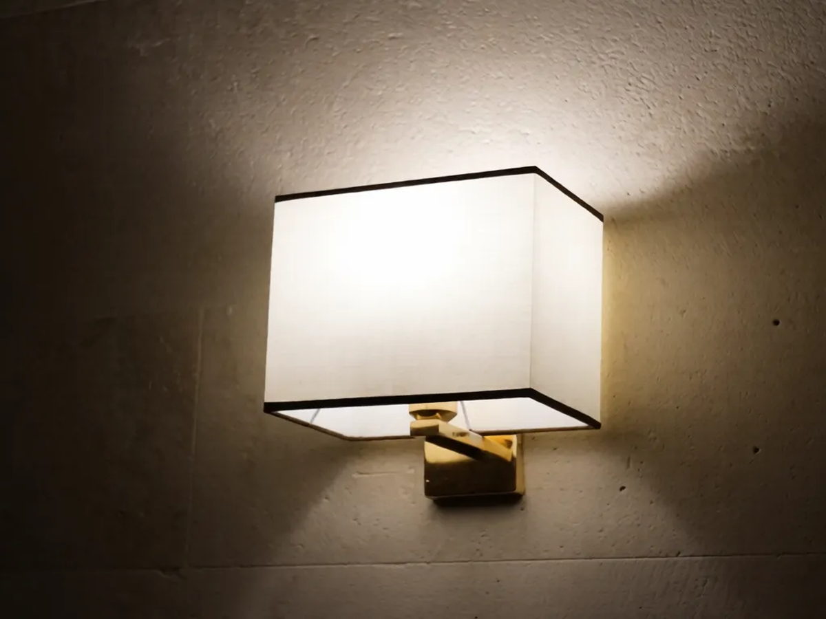 A brass reading light on limestone